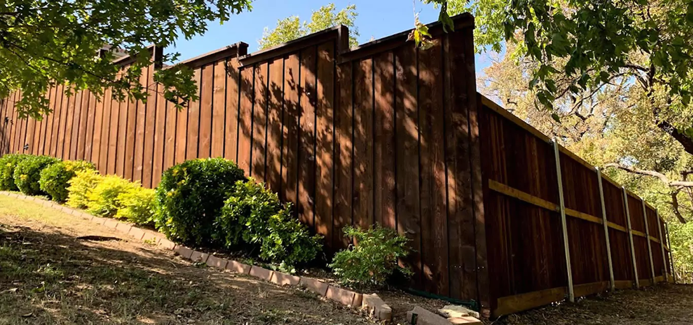 Step-down cedar fence on a sloped yard