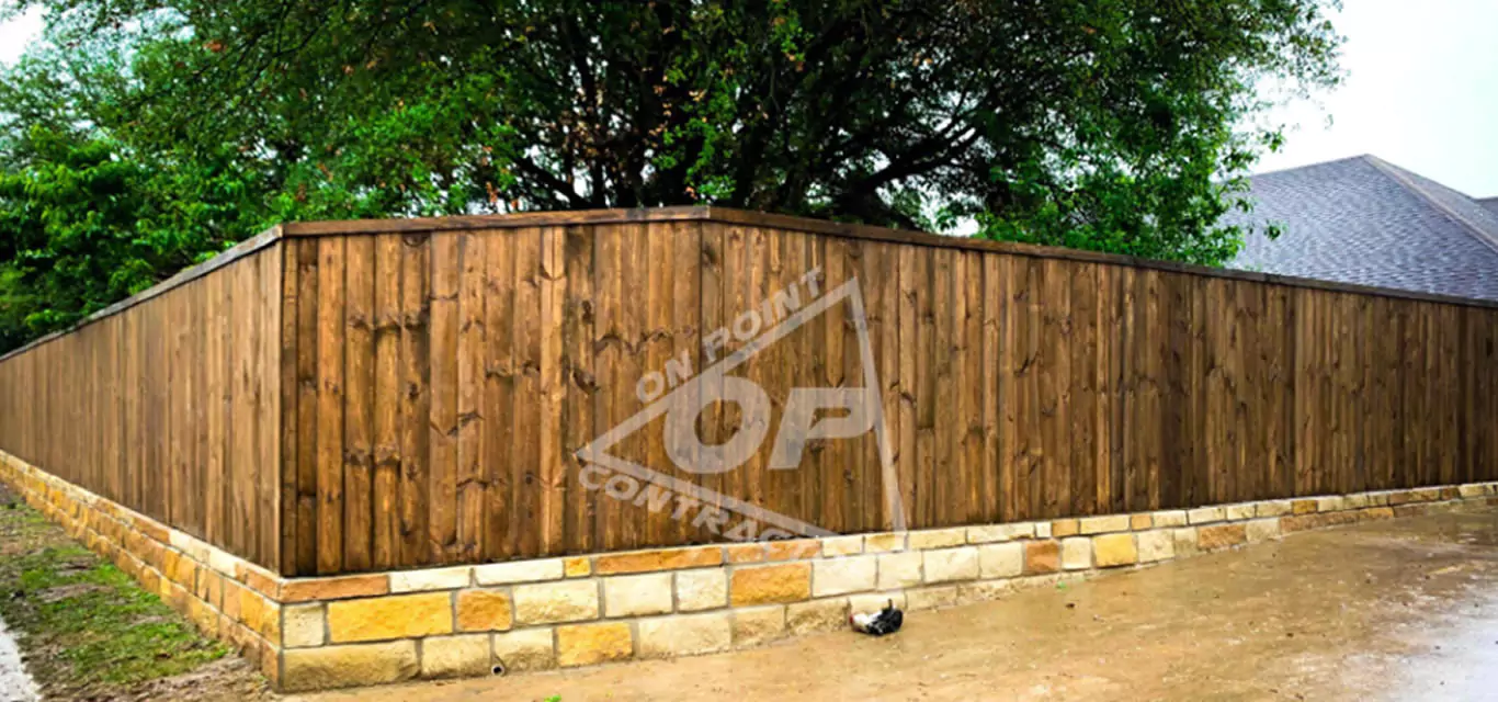 Cedar fence on a stone retaining wall