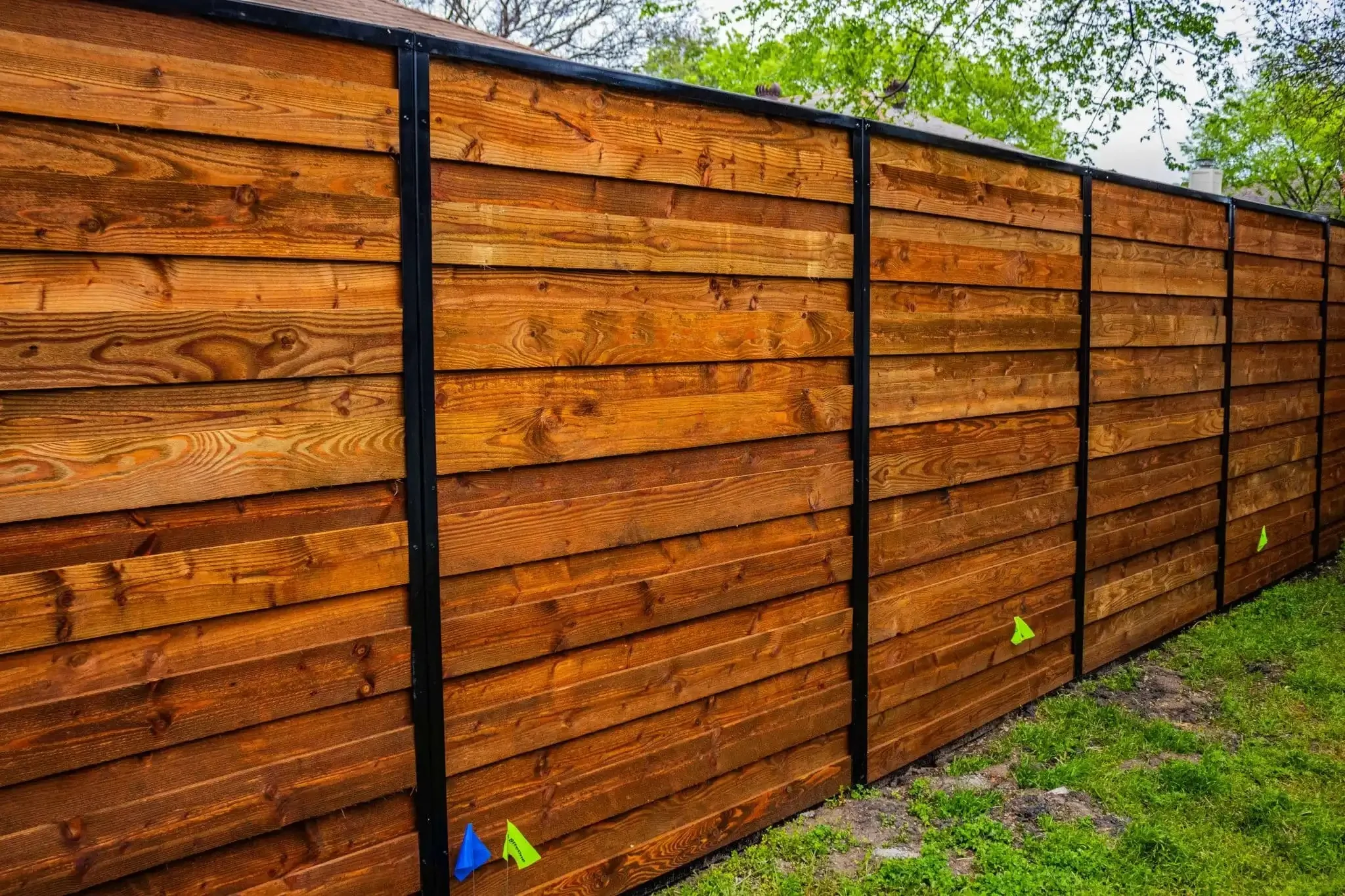 Estacado 8 ft horizontal board on board cedar fence with black metal frame