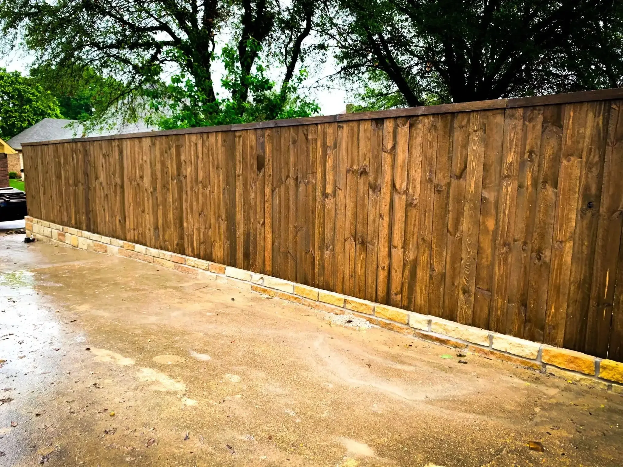 Cedar fence built on top of a stone retaining wall in DFW, photo 4
