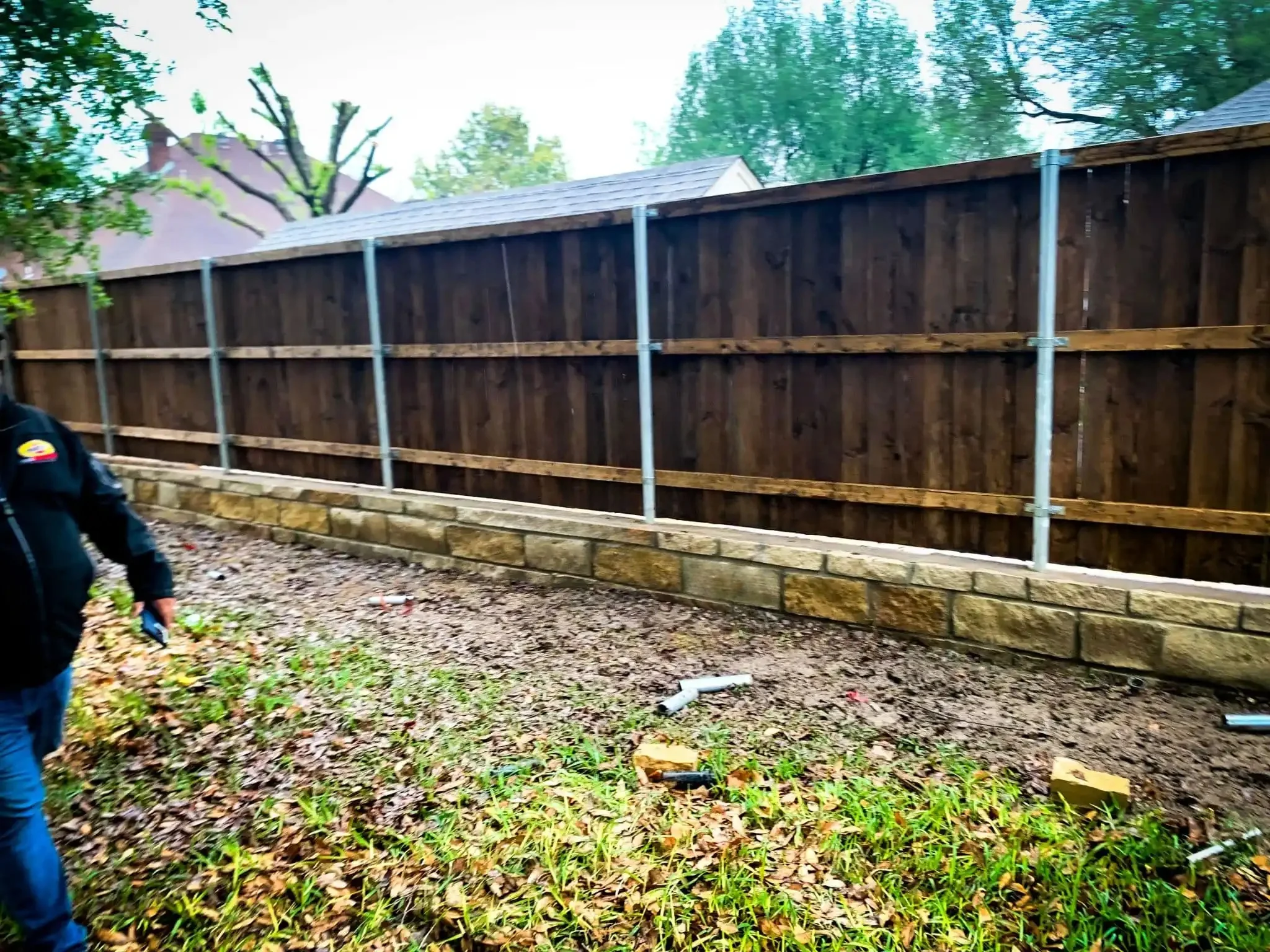 Cedar fence built on top of a stone retaining wall in DFW, photo 8