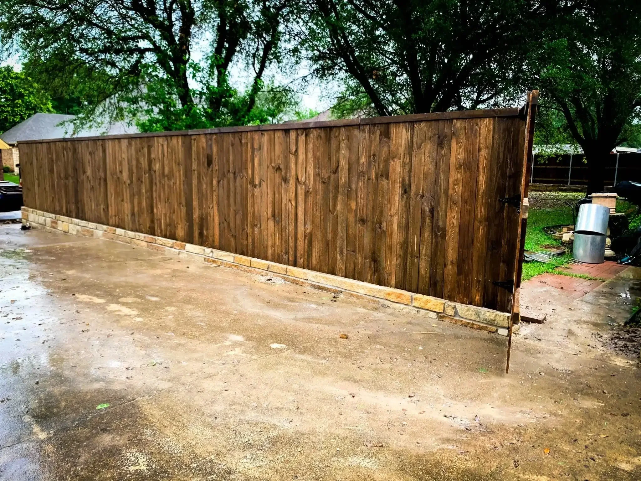 Cedar fence built on top of a stone retaining wall in DFW, photo 10