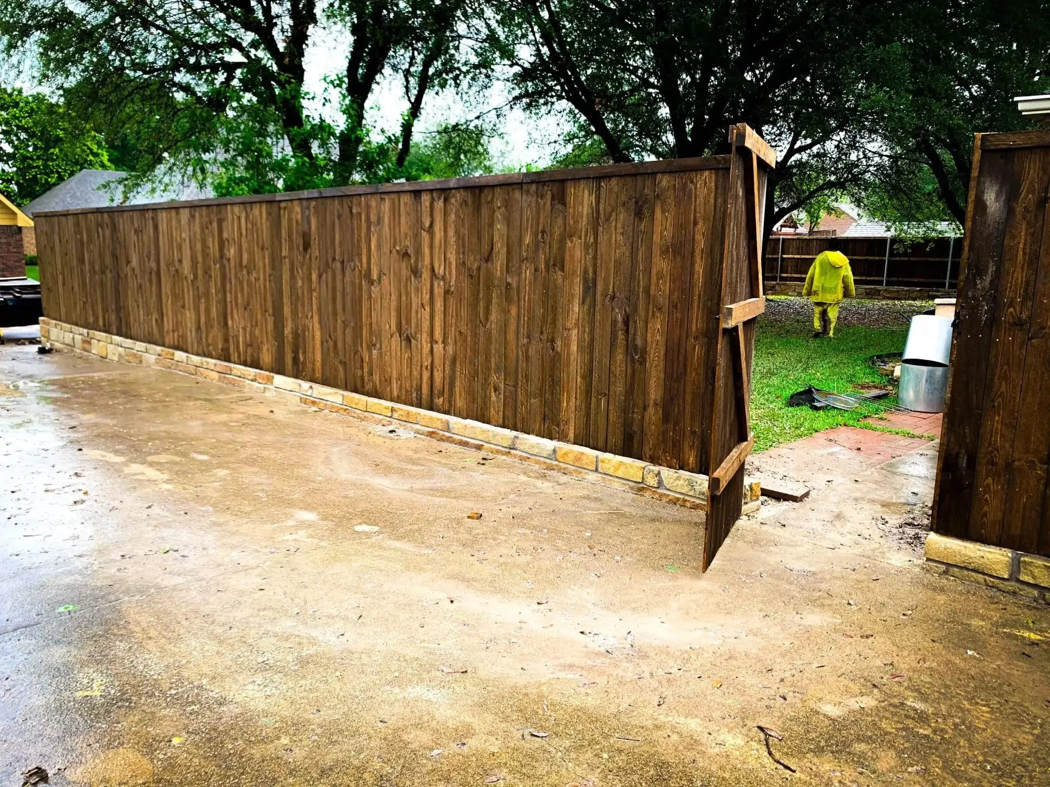 Cedar fence built on top of a stone retaining wall in DFW, photo 11