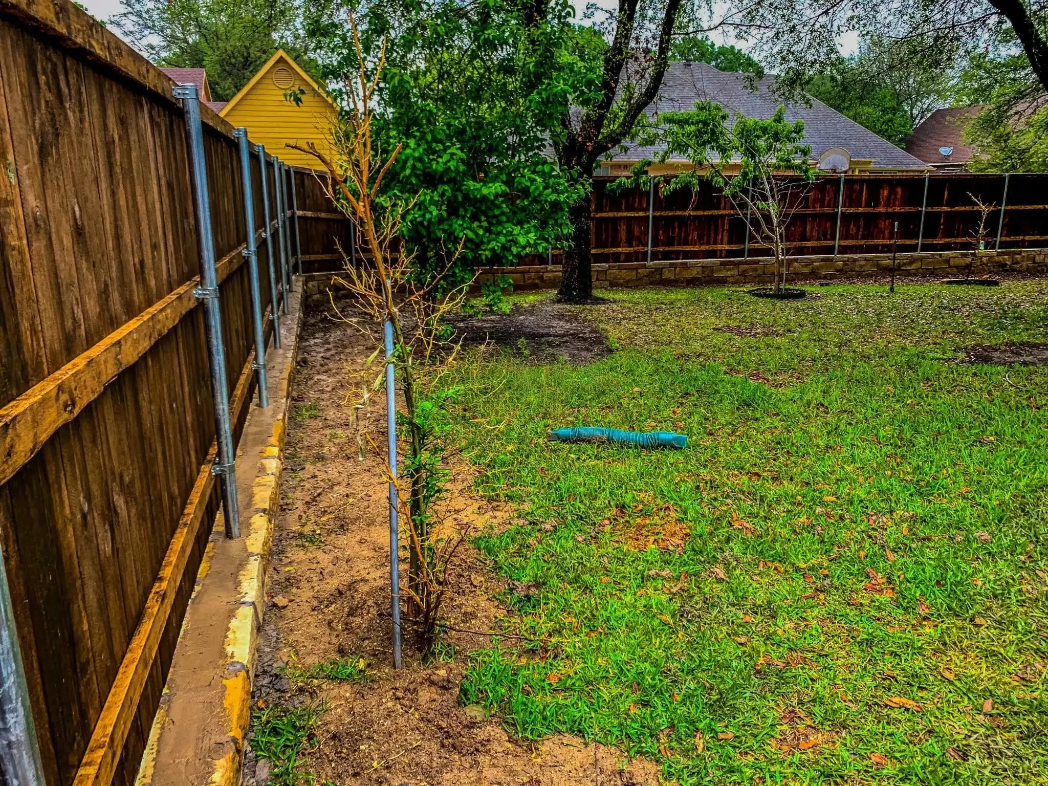 Cedar fence built on top of a stone retaining wall in DFW, photo 12