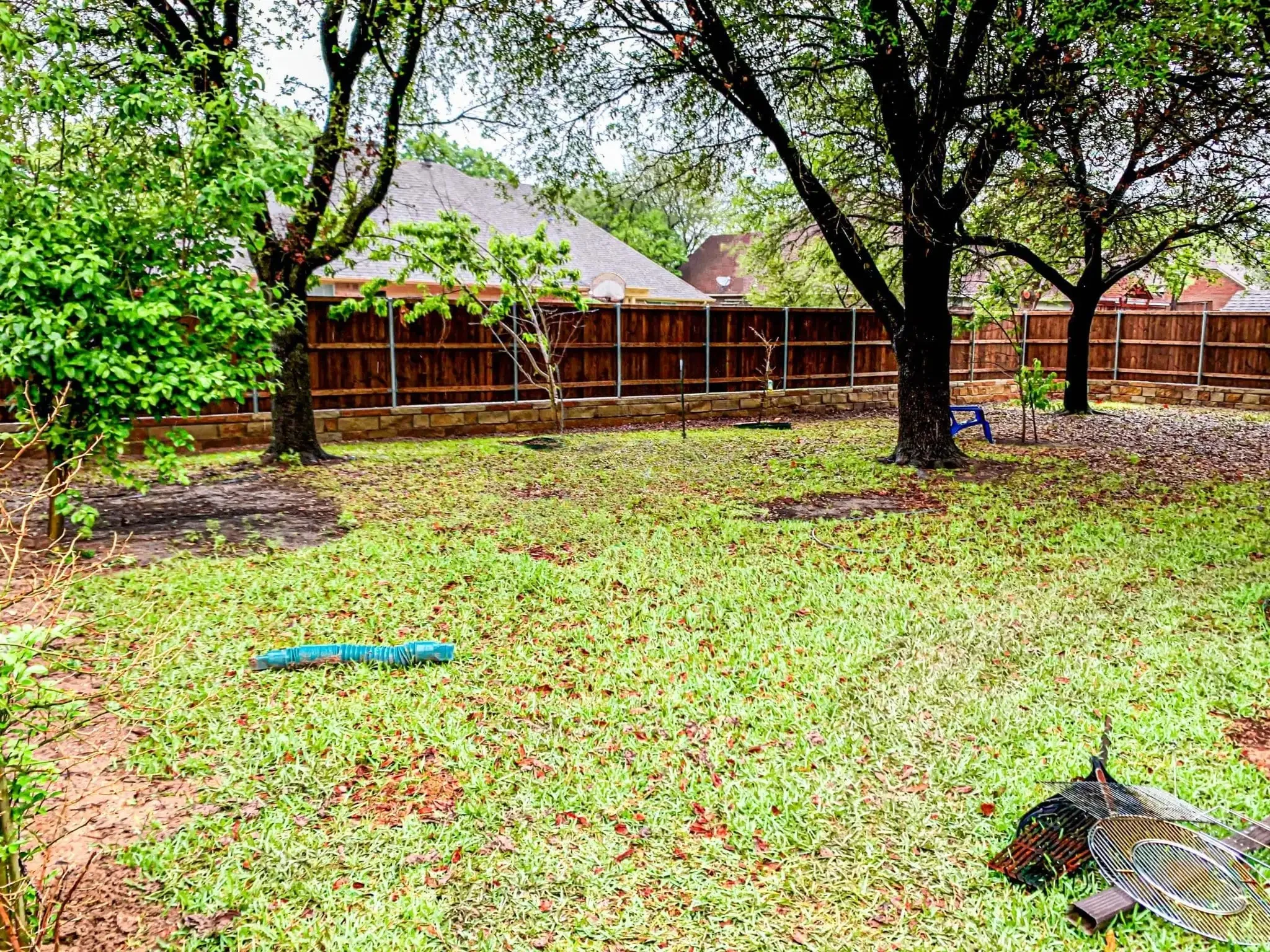Cedar fence built on top of a stone retaining wall in DFW, photo 13