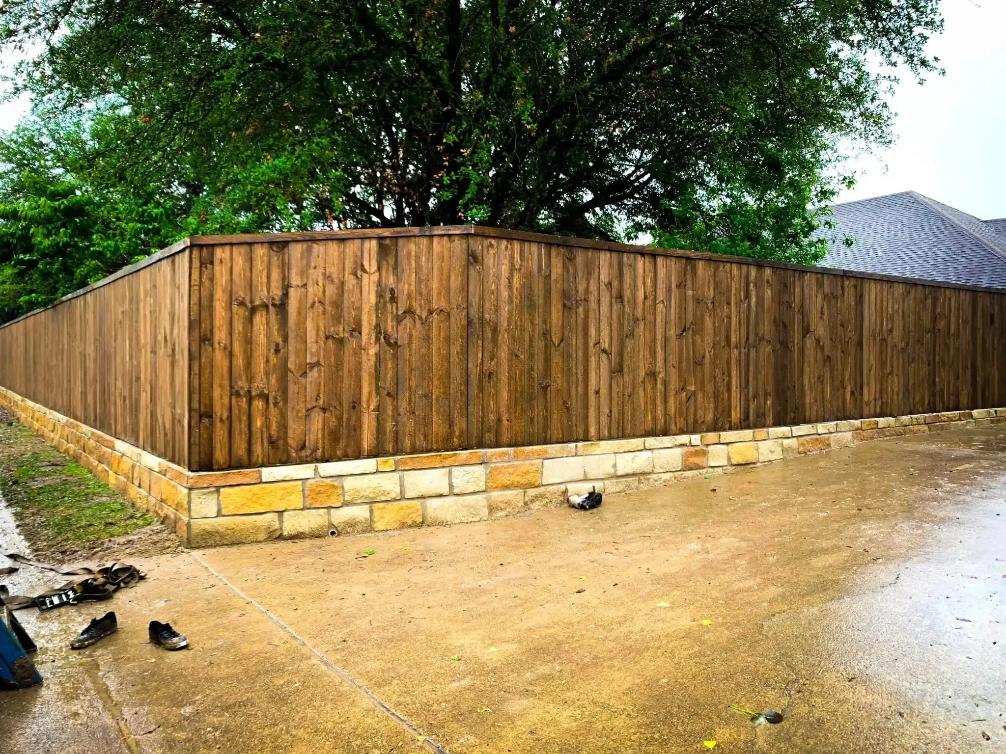 Cedar fence built on top of a stone retaining wall in DFW, photo 15