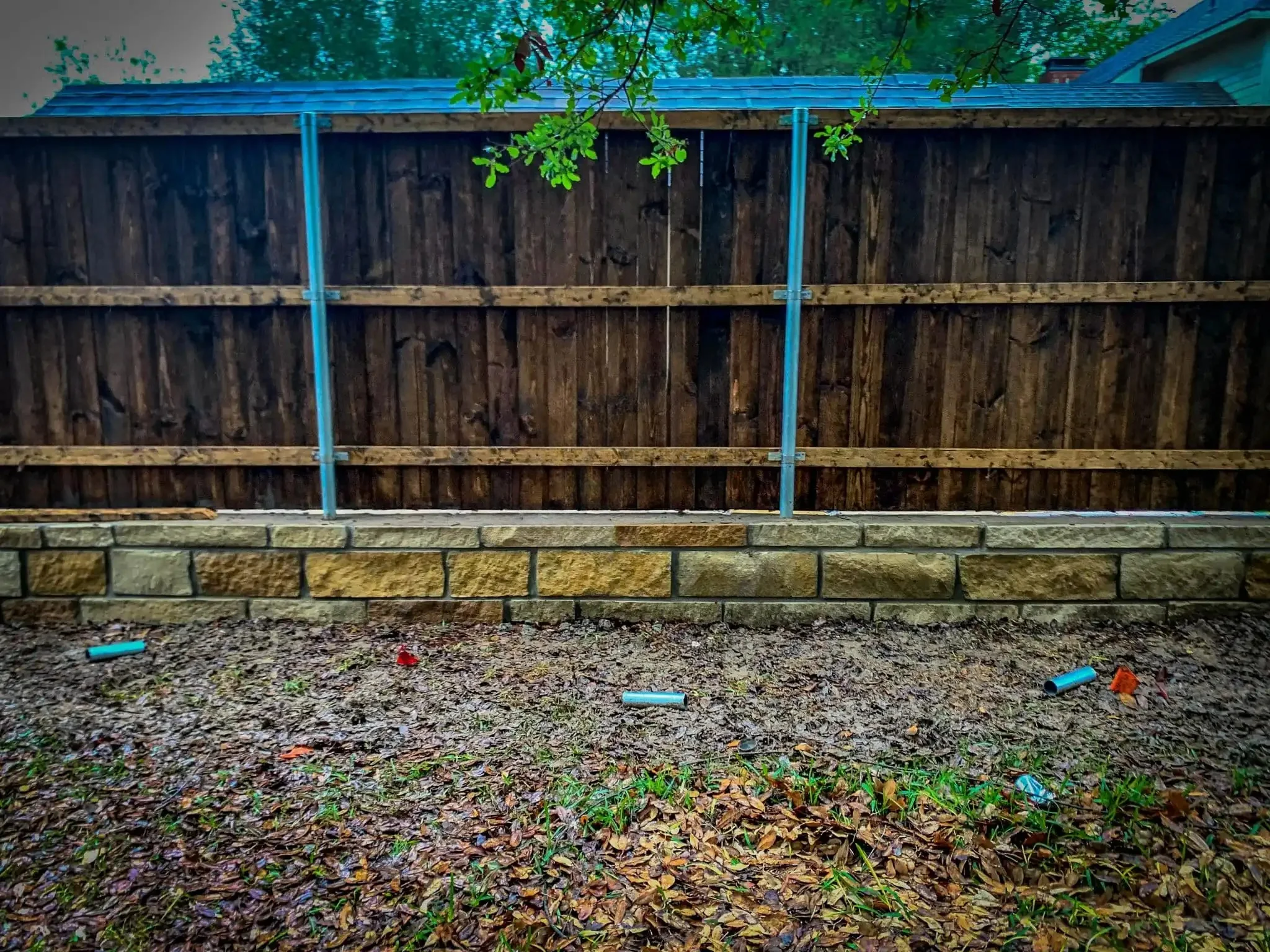 Cedar fence built on top of a stone retaining wall in DFW, photo 17
