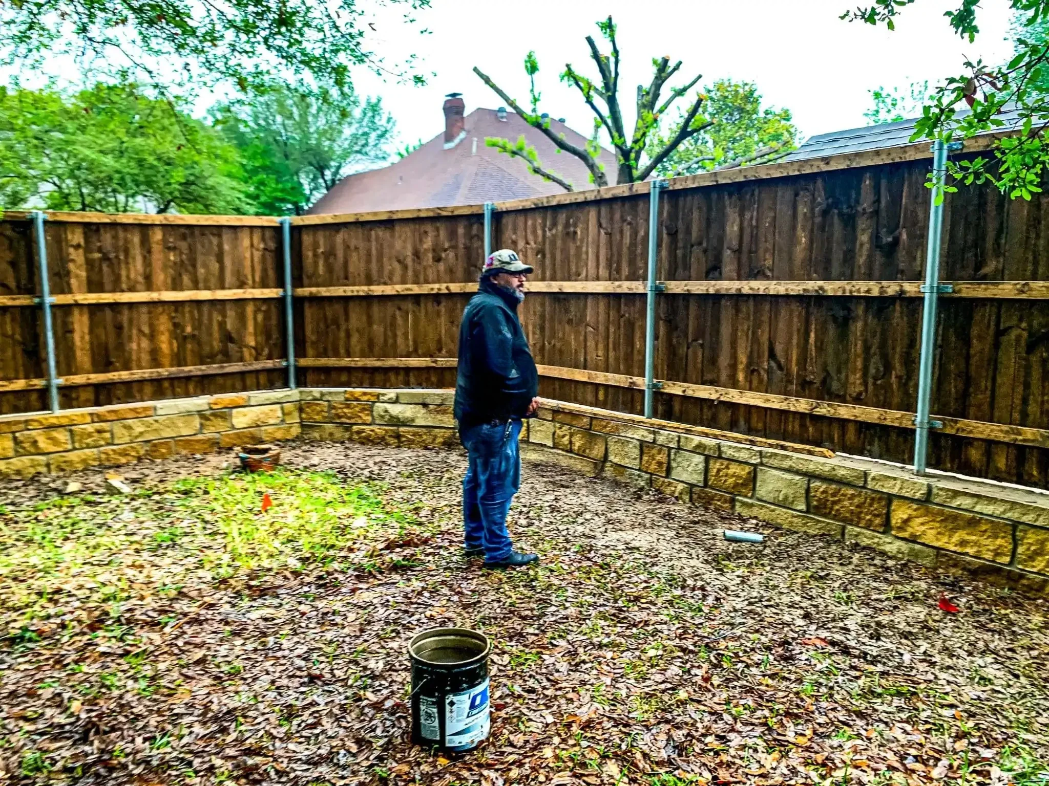 Cedar fence built on top of a stone retaining wall in DFW, photo 18