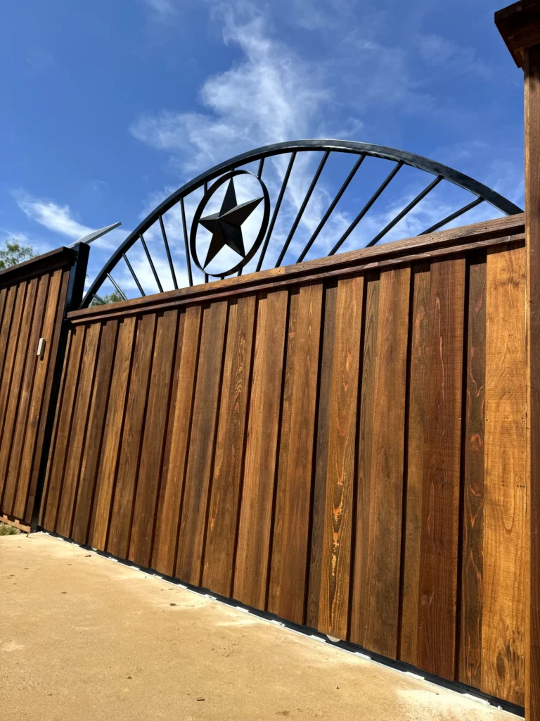 Custom welded automatic driveway gate with metal Texas star and commercial CSL LiftMaster motor in Burleson, Texas
